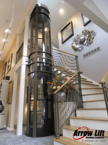 Glass Elevator with wrap around stairs - Arrow Lift 2020