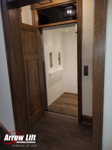 Home Elevator with Flat Panels and Dark Wood - Arrow Lift 2020