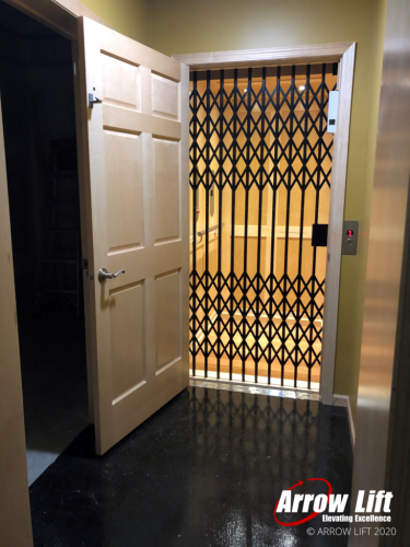 Modern Home Elevator with glass shaft and scissor gate - Arrow Lift 2020