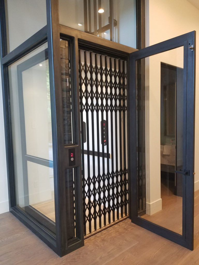 Glass and steel home elevator arrow lift