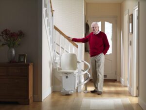 Man standing by a stair lift - Arrow Lift 2020