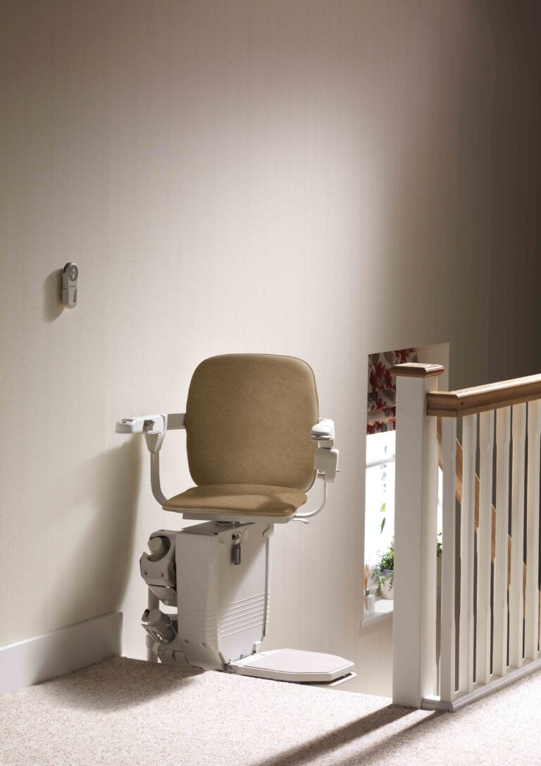 Stair lift with chair at top landing in pivoted position