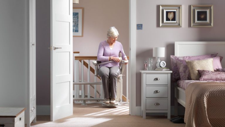 Woman using a stair lift with a seatbelt.