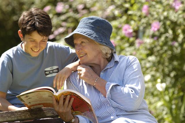 Adult and child reading in garden