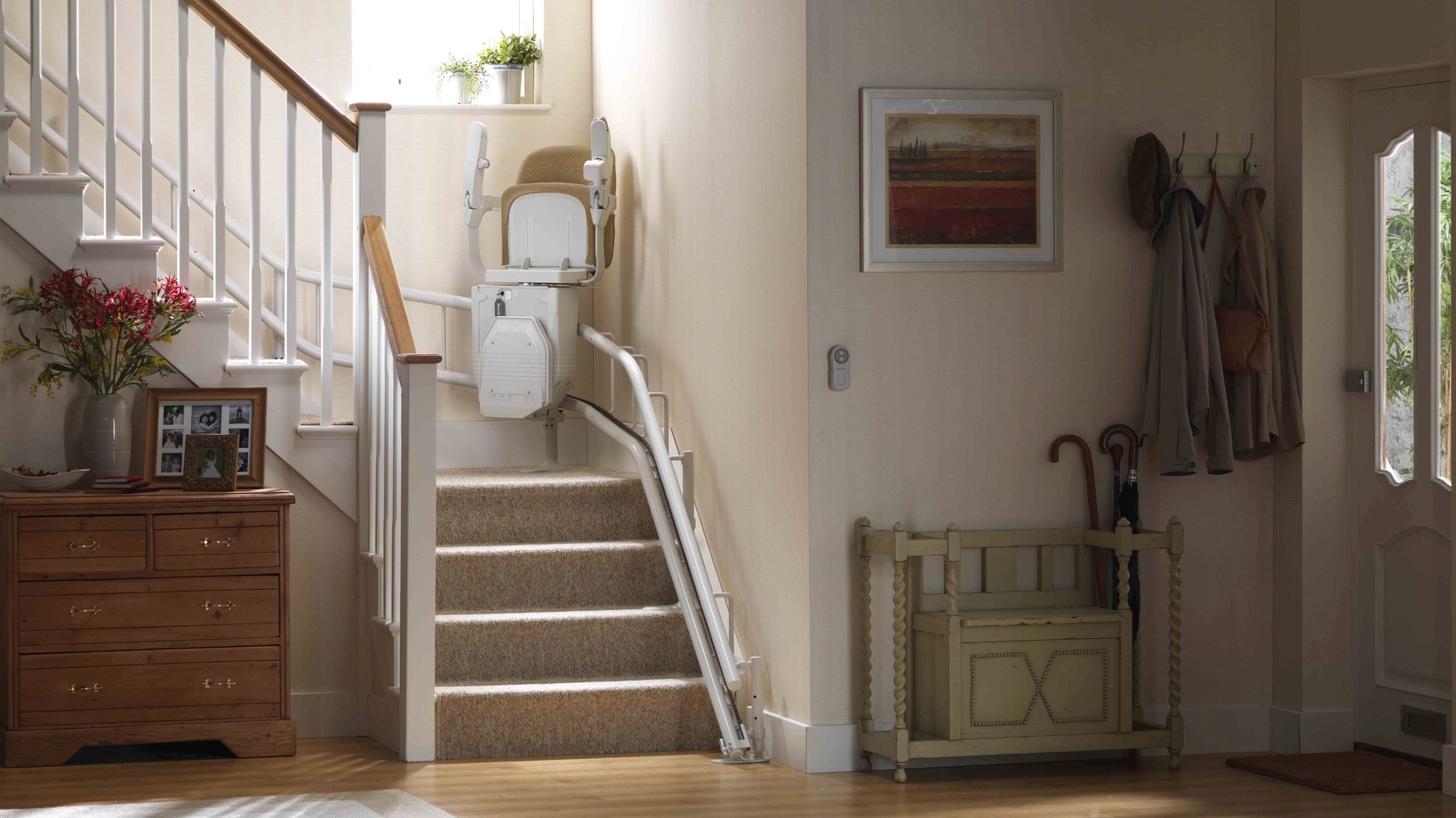 Stannah Siena curved stair lift with arms and seat up on the staircase. Arrow Lift.