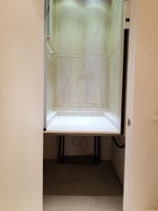 Close up of Pitless Home Elevator between floors highlighting that there is no pit at the bottom landing.