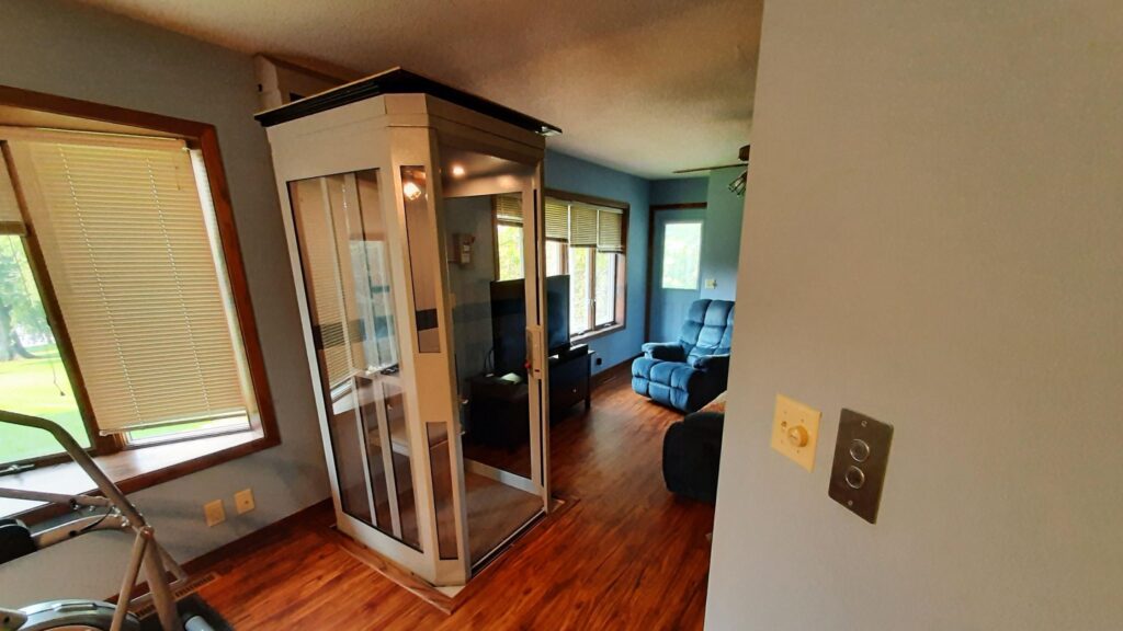 Shaftless Elevator situated between windows of family room
