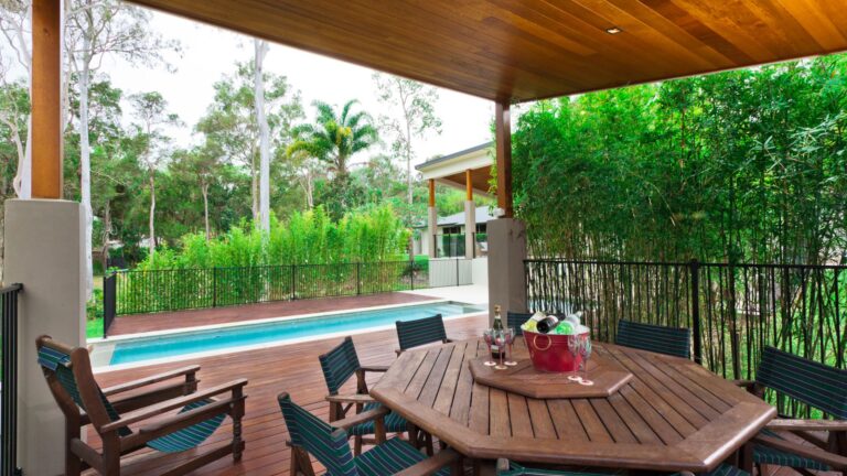 Outdoor living space for entertaining with large table and pool