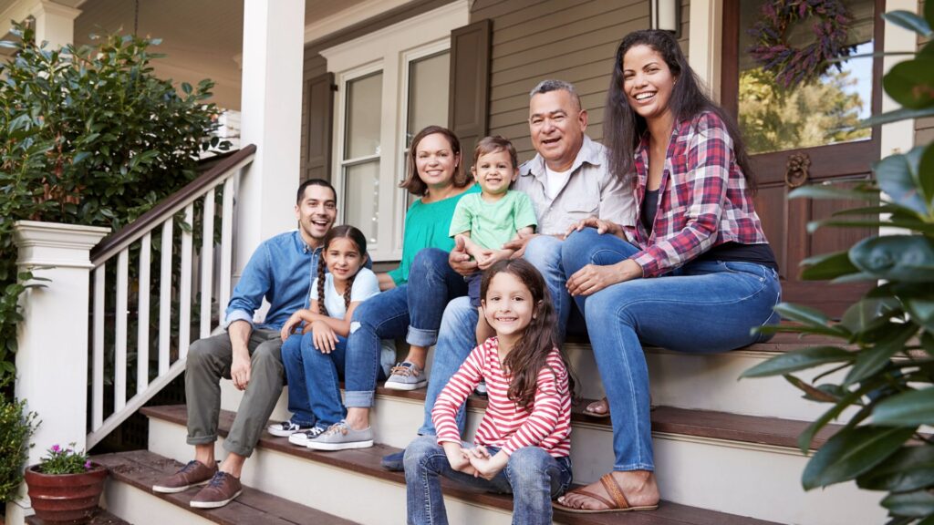 Images of Multi-generational family on front steps of the family home. 