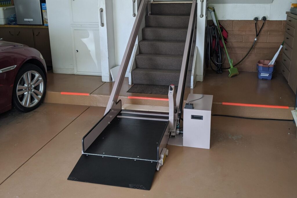 Image of an Incline Platform lift at base of the stairs