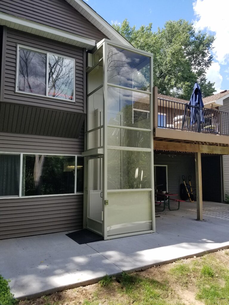 Enclosed wheelchair lift on the exterior of the building.