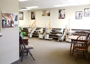 Multiple stair lift models at the base of the stairs in the Bloomington Arrow Lift Showroom