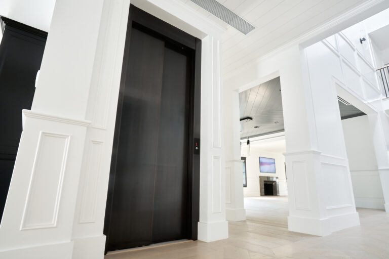 A sleek, modern, black elevator fits seamlessly into a contemporary home.