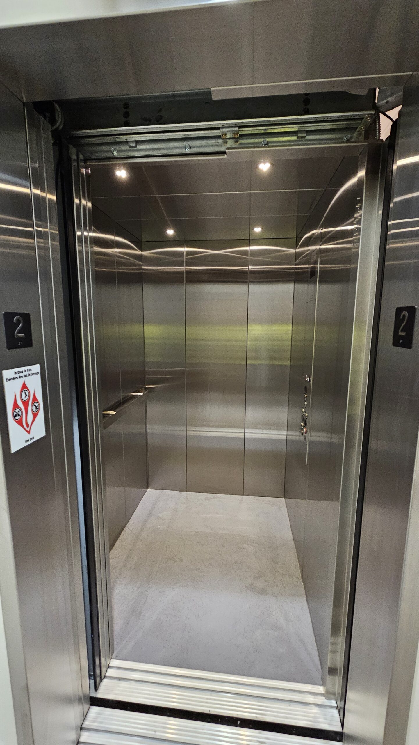 LULA elevator with stainless steel finish in a high school