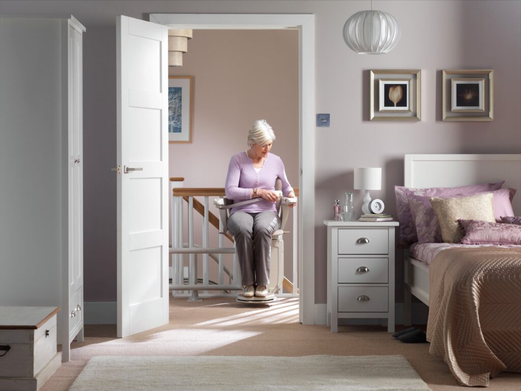 Woman attaching the seatbelt while seated in a stair lift chair