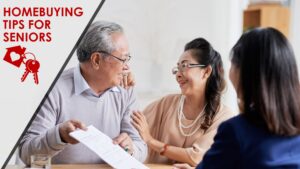 An elderly man and woman look at each other happily as they review a document with an advisor.