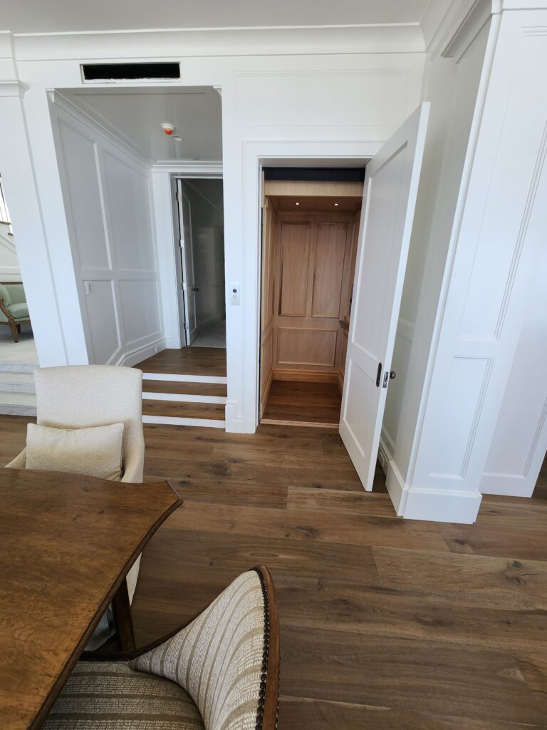 traditional home elevator with wood panels