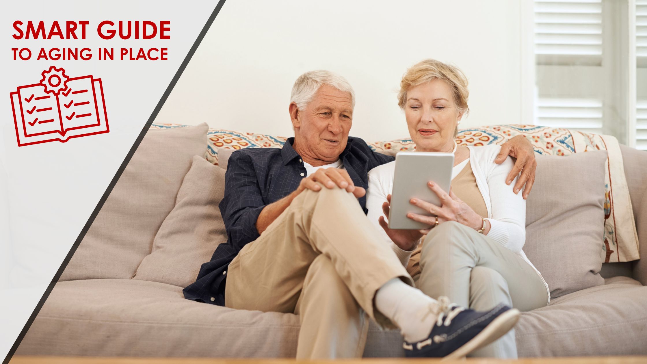 Older couple seated on a couch looking at a tablet, technical guide icon