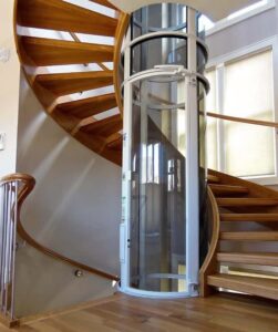 vacuum elevator with white trim at the center of a spiral stair case